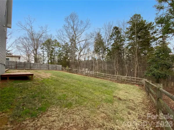 a view of a backyard with large trees