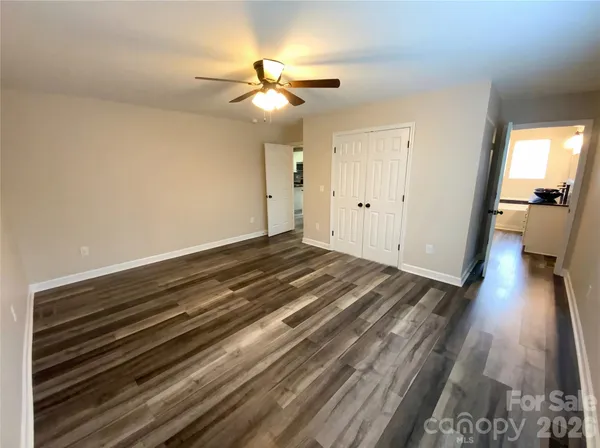 a view of a room with wooden floor