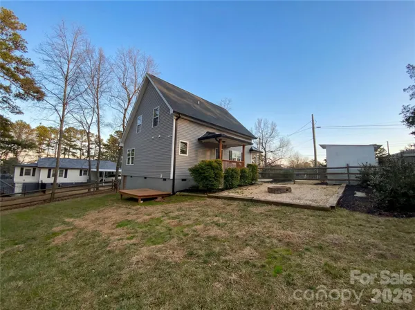 a backyard of a house with table and chairs