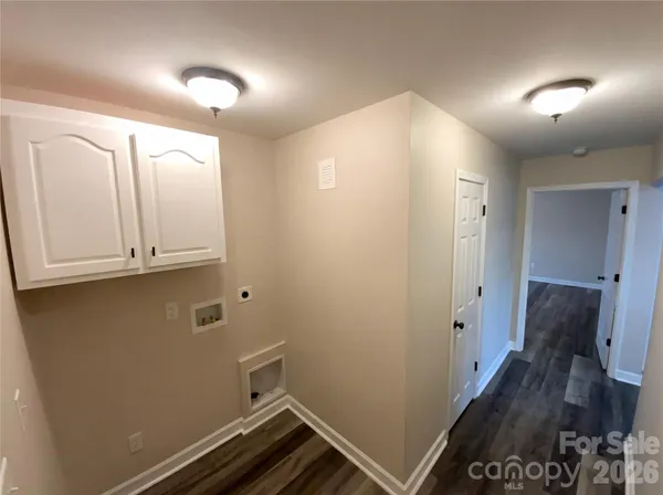 a view of room with hallway and wooden floor
