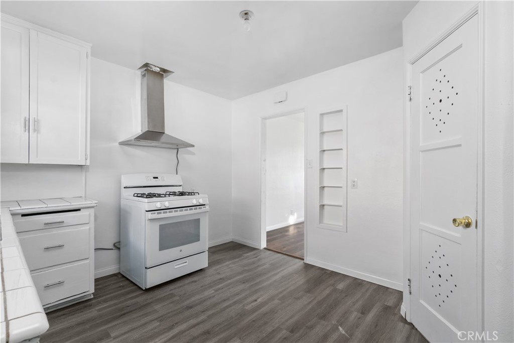 735 Michigan Avenue Beaumont, CA 92223 - Photo 2 of 19 a kitchen with white cabinets and white appliances