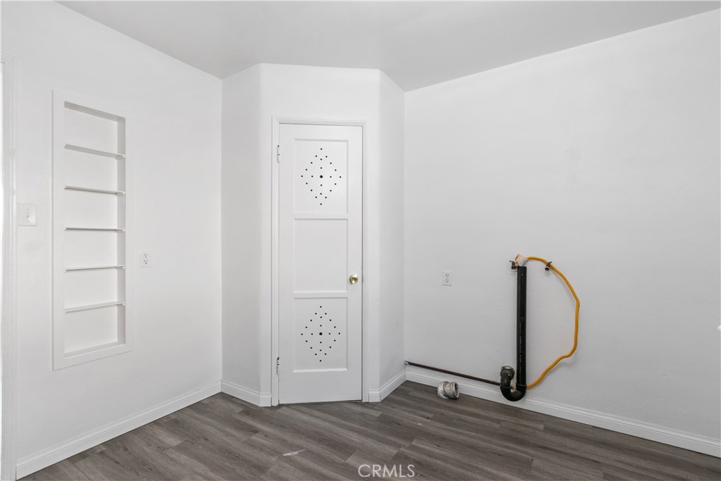 735 Michigan Avenue Beaumont, CA 92223 - Photo 3 of 19 a view of a room with wooden floor and a ceiling fan