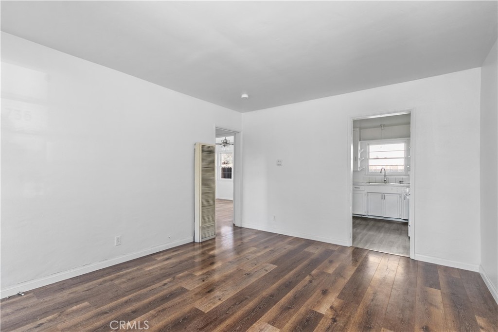 735 Michigan Avenue Beaumont, CA 92223 - Photo 5 of 19 a view of an empty room with wooden floor and a window