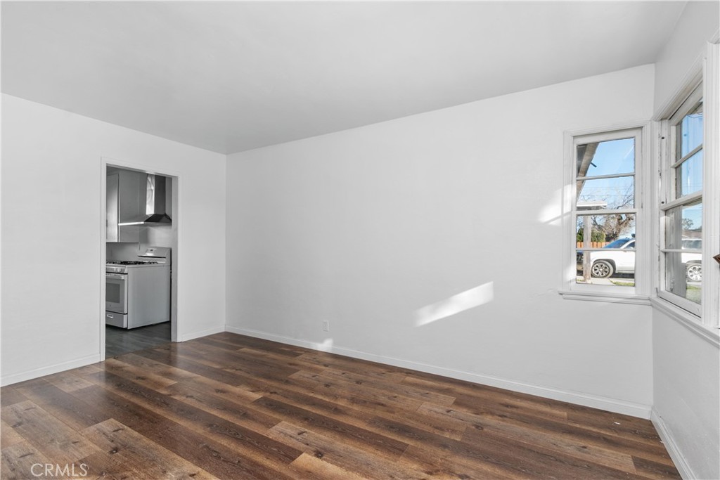 735 Michigan Avenue Beaumont, CA 92223 - Photo 6 of 19 a view of empty room with wooden floor