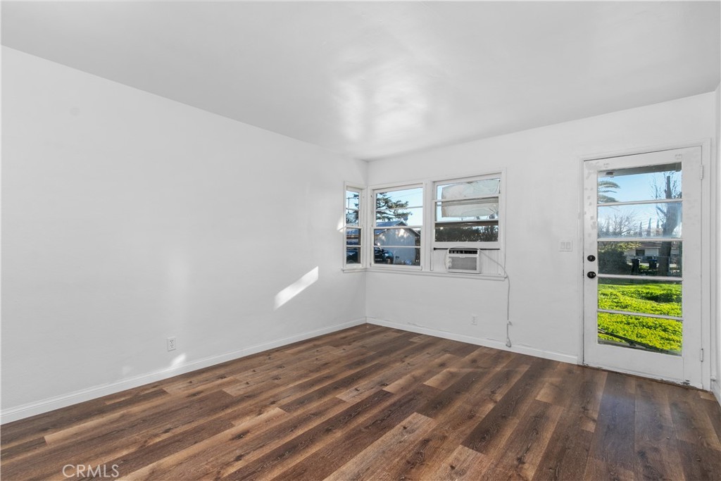 735 Michigan Avenue Beaumont, CA 92223 - Photo 7 of 19 a view of empty room with wooden floor and fan