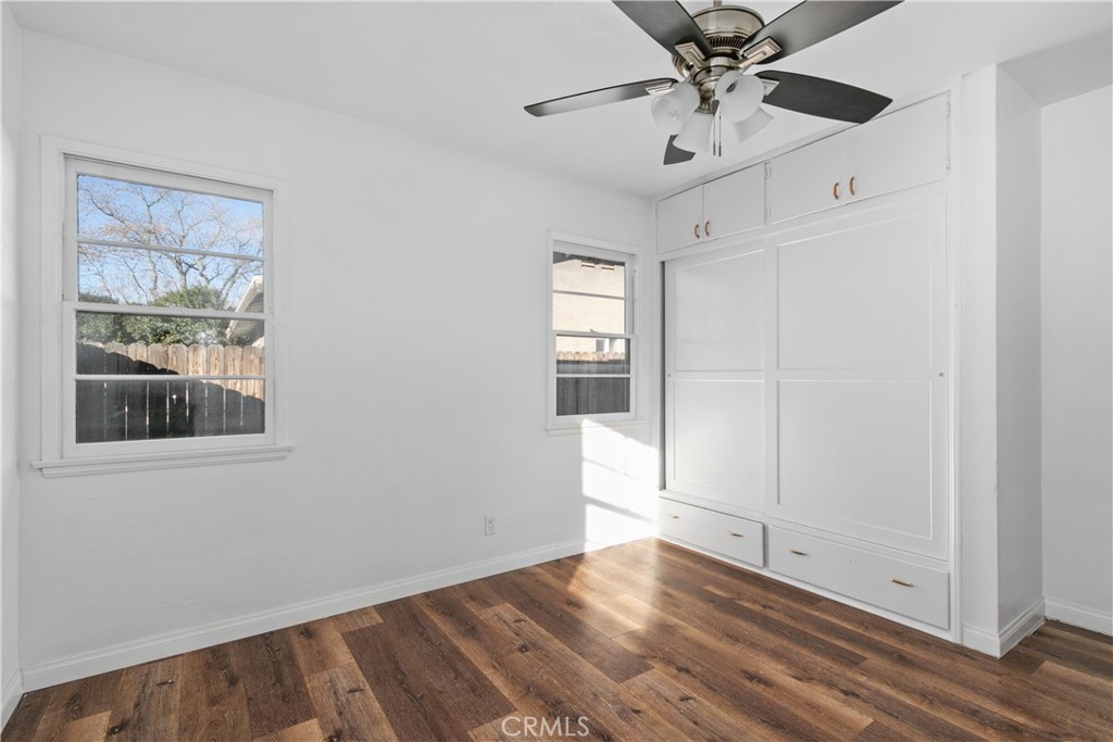 735 Michigan Avenue Beaumont, CA 92223 - Photo 10 of 19 a view of an empty room with a window and wooden floor