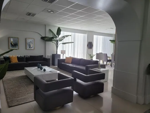 a media room with lots of chairs and a projector screen