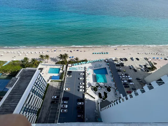 a view of swimming pool with outdoor seating and yard in back