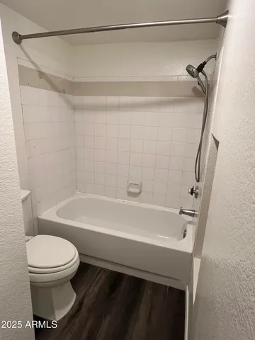 a bathroom with a bathtub and a toilet