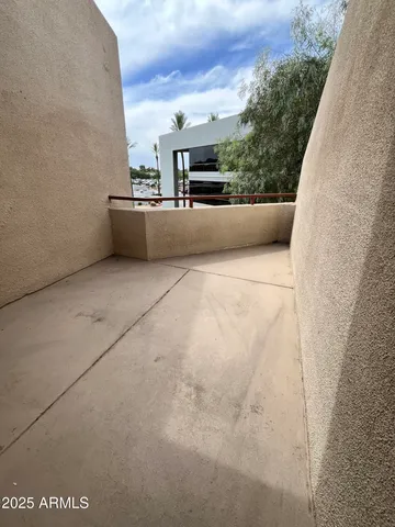 a view of balcony with outdoor seating and a forest