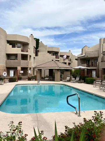 a view of a swimming pool with a lounge chair