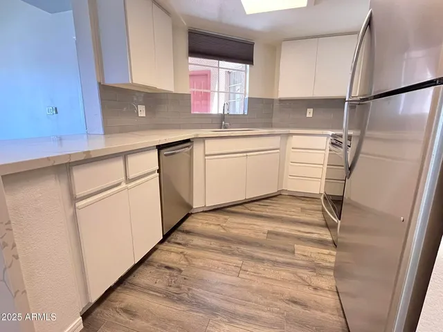 a kitchen with a sink cabinets and window