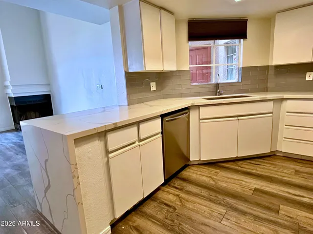 a kitchen with stainless steel appliances granite countertop a sink a stove and a microwave