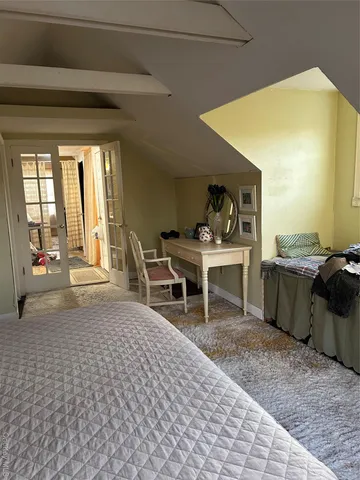 a living room with furniture a flat screen tv and next to a window