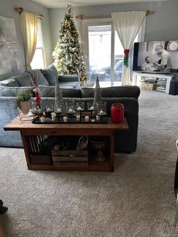 a living room with furniture and a chandelier