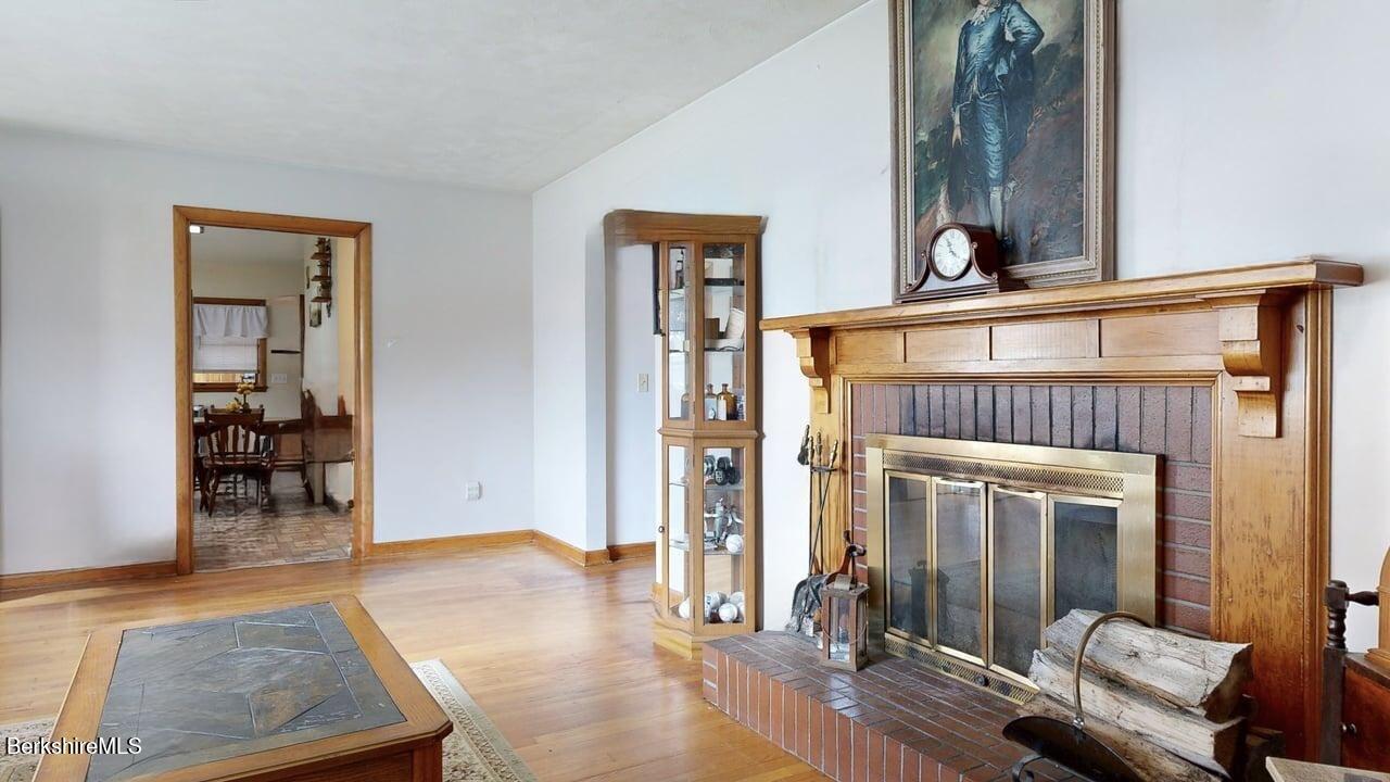 16 Anthony Street Adams, MA 01220 - Photo 10 of 33 a living room with furniture a flat screen tv and a fireplace