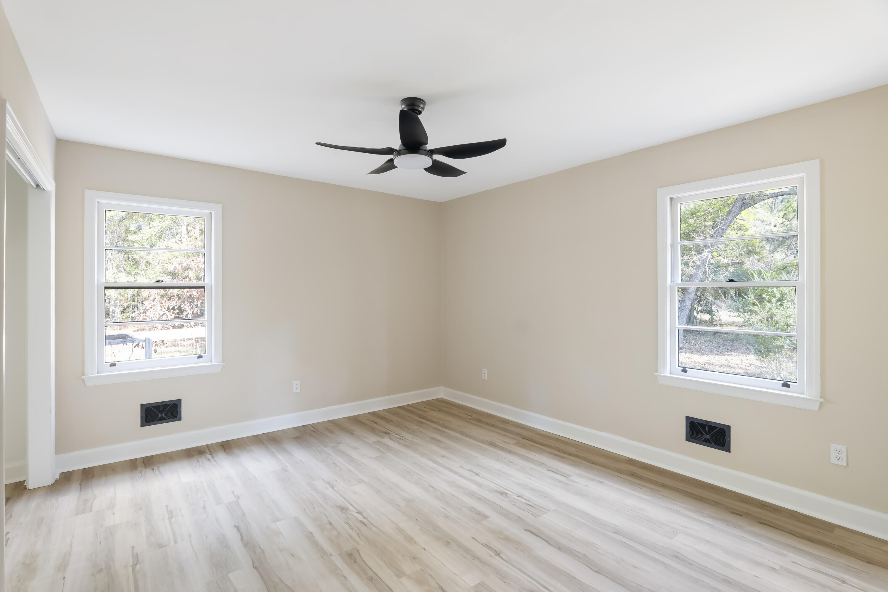 39 Gantt Street Wagener, SC 29164 - Photo 17 of 30 a view of an empty room with wooden floor and a window