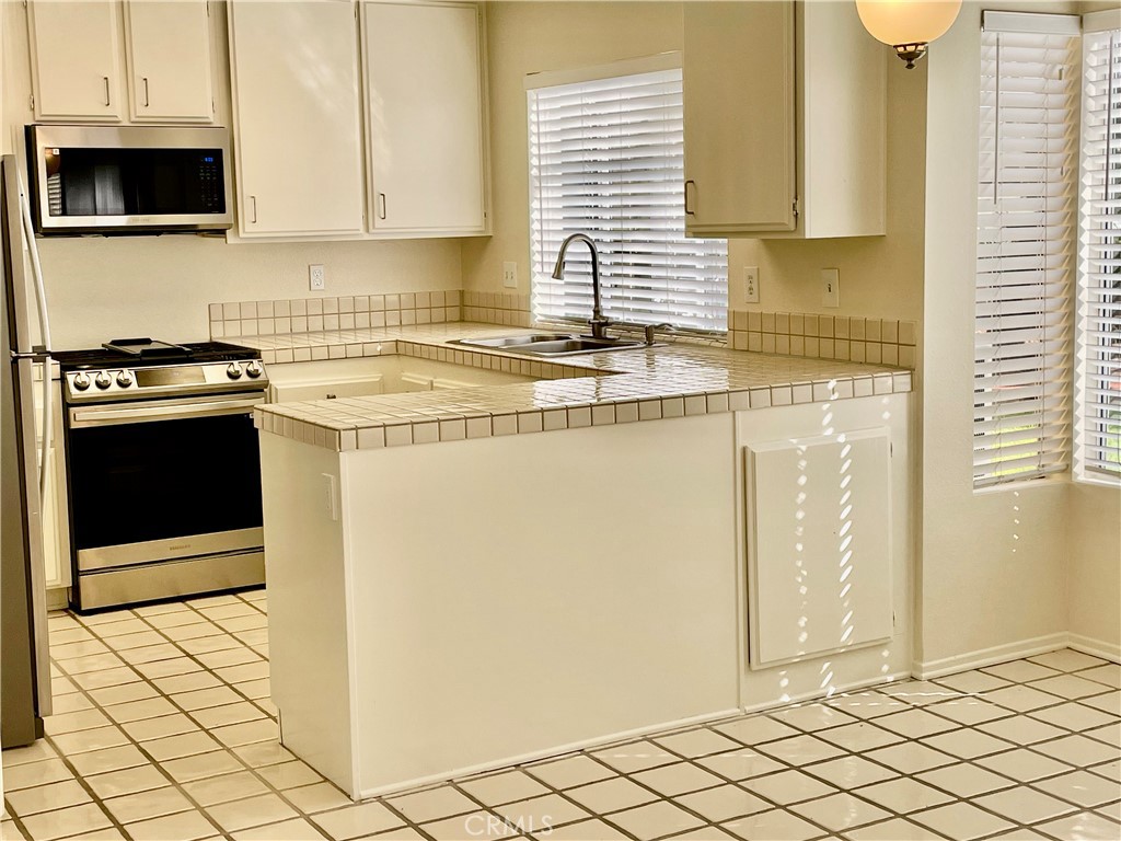 28182 Rancho Azul Laguna Niguel, CA 92677 - Photo 16 of 39 a kitchen with stainless steel appliances a stove a sink and a refrigerator