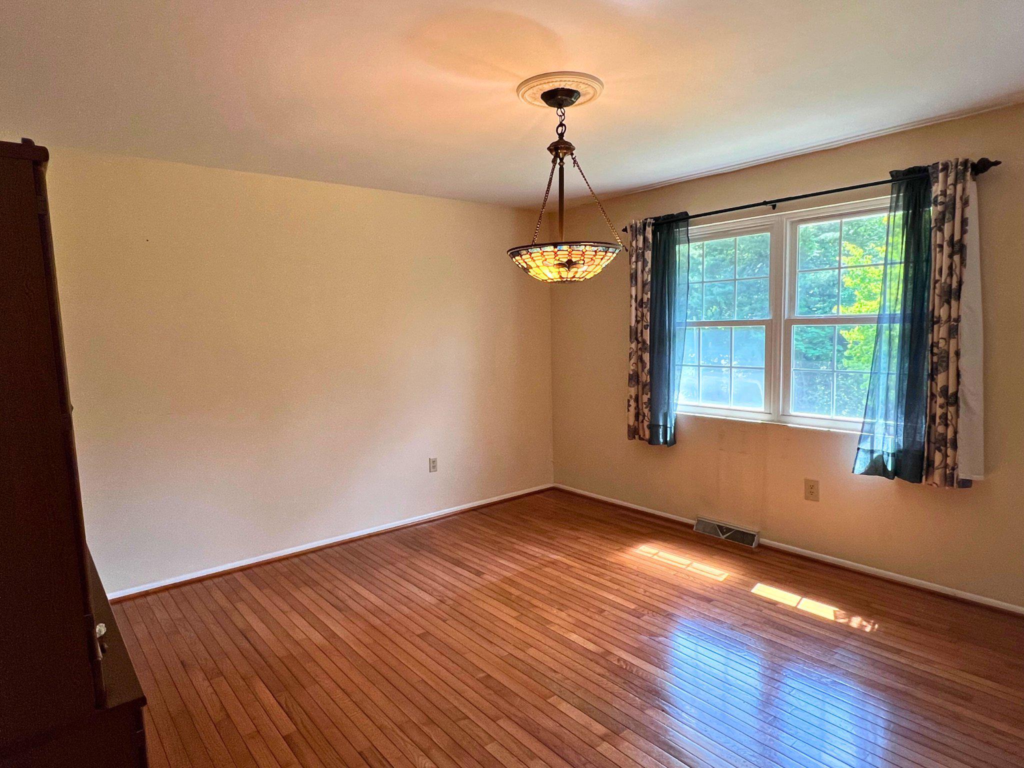 8531 Solomons Island Road North Owings, MD 20736 - Photo 7 of 12 a view of empty room with wooden floor and fan