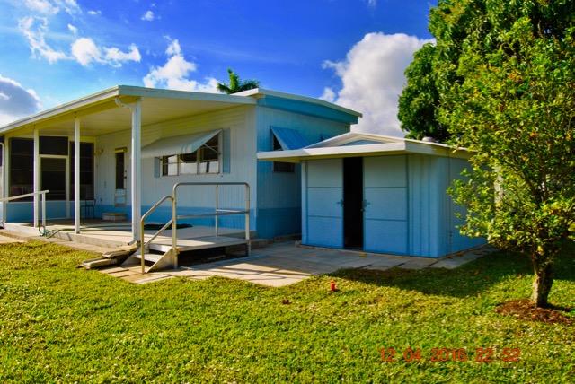 7039 Southeast Ridgeway Terrace Hobe Sound, FL 33455 - Photo 6 of 38 Rear and Shed