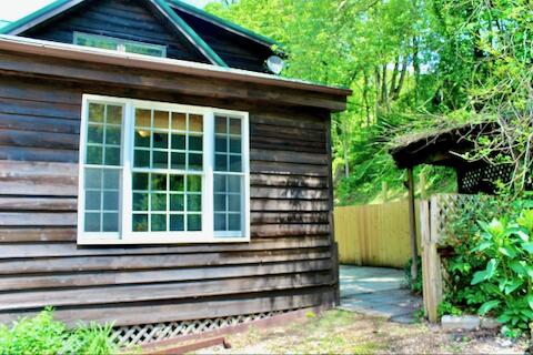 182 Rose Road Newport, VA 24128 - Photo 36 of 69 a view of a house with a large window and flower plants