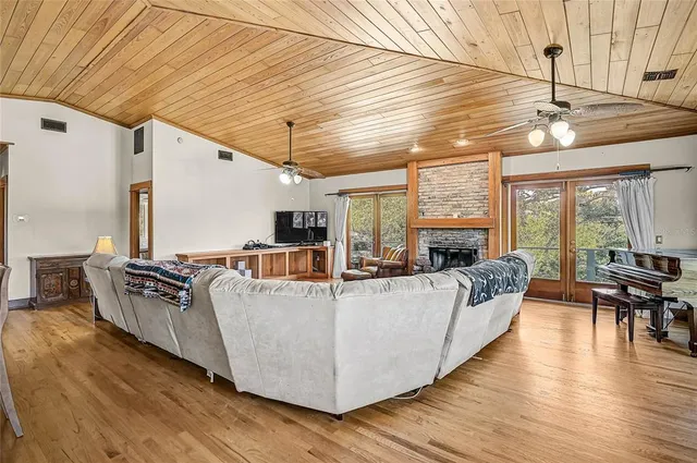 a living room with furniture wooden floor and large window