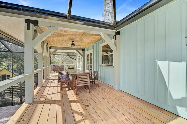 a view of a porch with a table and chairs