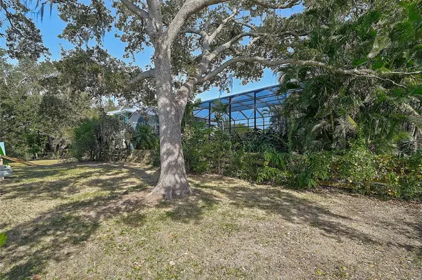 a view of a house with a yard and furniture