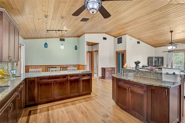 a kitchen with stainless steel appliances granite countertop a stove and cabinets