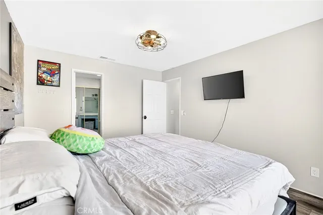 a bedroom with a bed and a flat screen tv