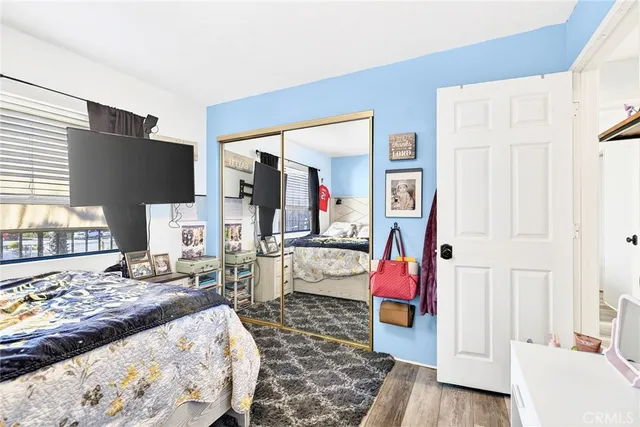 a bedroom with furniture and wooden floor