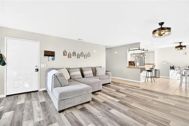 a living room with furniture and a wooden floor