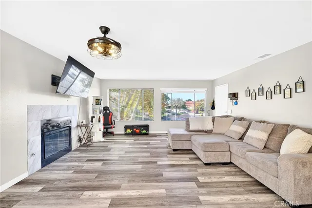 a living room with furniture and fireplace