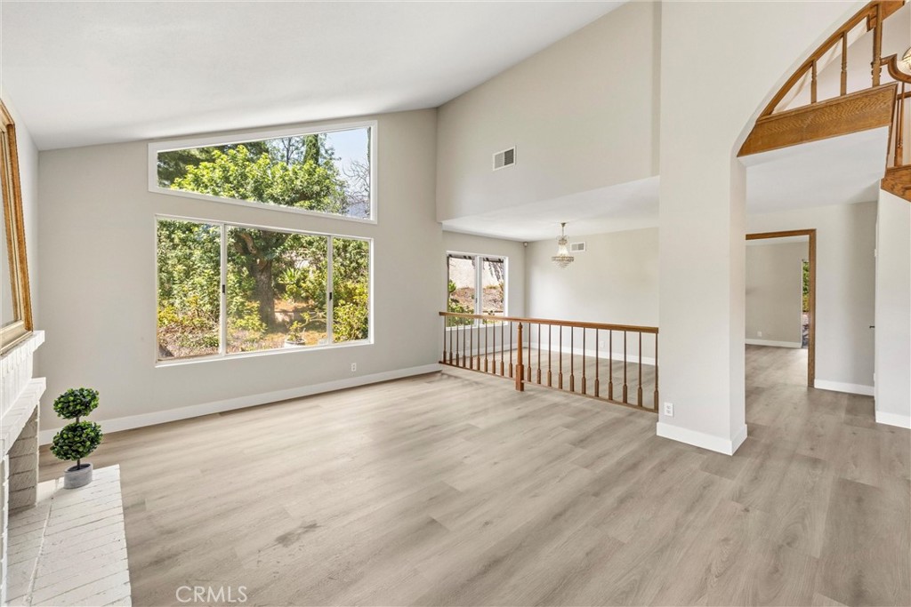 5895 Jadeite Avenue Rancho Cucamonga, CA 91737 - Photo 15 of 71 a view of an empty room with wooden floor and a window
