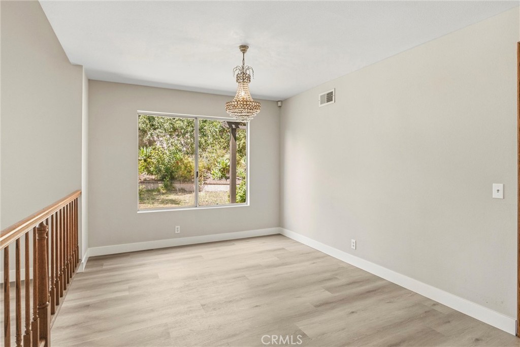 5895 Jadeite Avenue Rancho Cucamonga, CA 91737 - Photo 17 of 71 an empty room with wooden floor and windows
