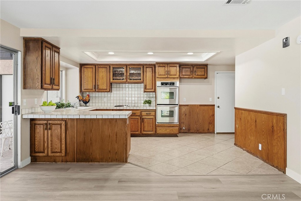 5895 Jadeite Avenue Rancho Cucamonga, CA 91737 - Photo 21 of 71 a kitchen with stainless steel appliances granite countertop a stove a sink and a microwave
