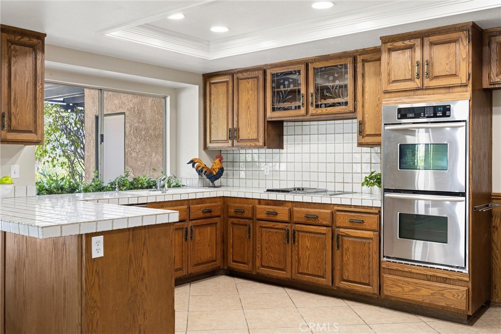5895 Jadeite Avenue Rancho Cucamonga, CA 91737 - Photo 24 of 71 a kitchen with stainless steel appliances granite countertop a sink stove and refrigerator
