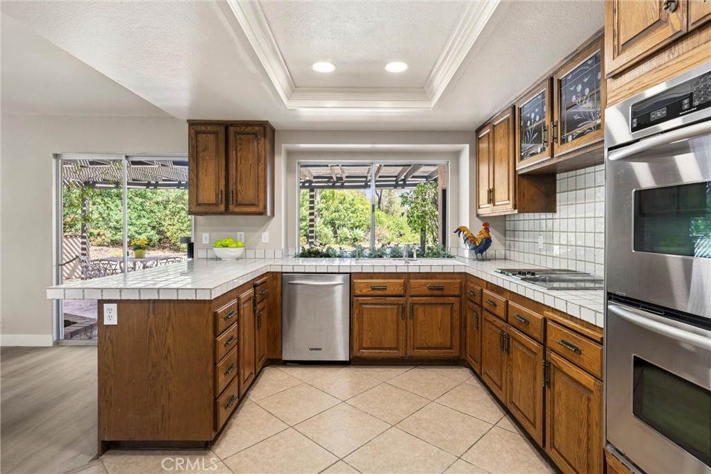 5895 Jadeite Avenue Rancho Cucamonga, CA 91737 - Photo 25 of 71 a kitchen with stainless steel appliances granite countertop a sink and cabinets