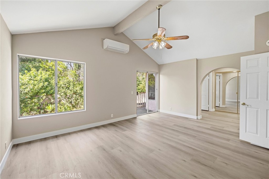 5895 Jadeite Avenue Rancho Cucamonga, CA 91737 - Photo 31 of 71 an empty room with wooden floor chandelier and windows