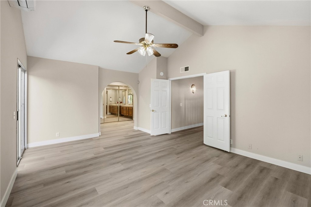 5895 Jadeite Avenue Rancho Cucamonga, CA 91737 - Photo 32 of 71 a view of a livingroom with wooden floor and a ceiling fan