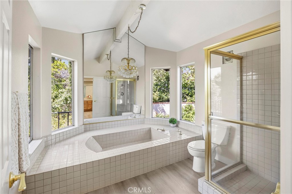 5895 Jadeite Avenue Rancho Cucamonga, CA 91737 - Photo 34 of 71 a bathroom with a bathtub a toilet and a shower