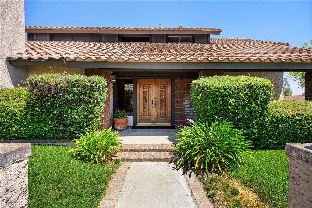 5895 Jadeite Avenue Rancho Cucamonga, CA 91737 - Photo 4 of 71 a view of a house with potted plants and a large tree