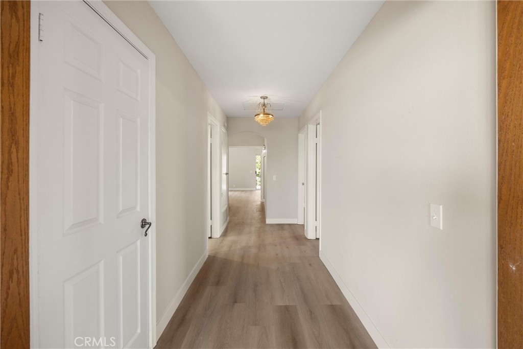 5895 Jadeite Avenue Rancho Cucamonga, CA 91737 - Photo 44 of 71 a view of a hallway with wooden floor