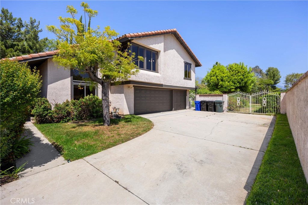 5895 Jadeite Avenue Rancho Cucamonga, CA 91737 - Photo 52 of 71 a front view of a house with a yard and potted plants