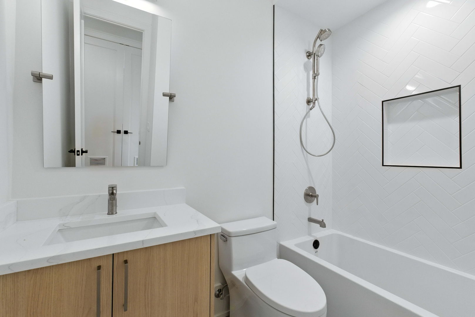 1443 West Roscoe Street, Unit 1 Chicago, IL 60657 - Photo 11 of 15 a bathroom with a sink toilet and shower