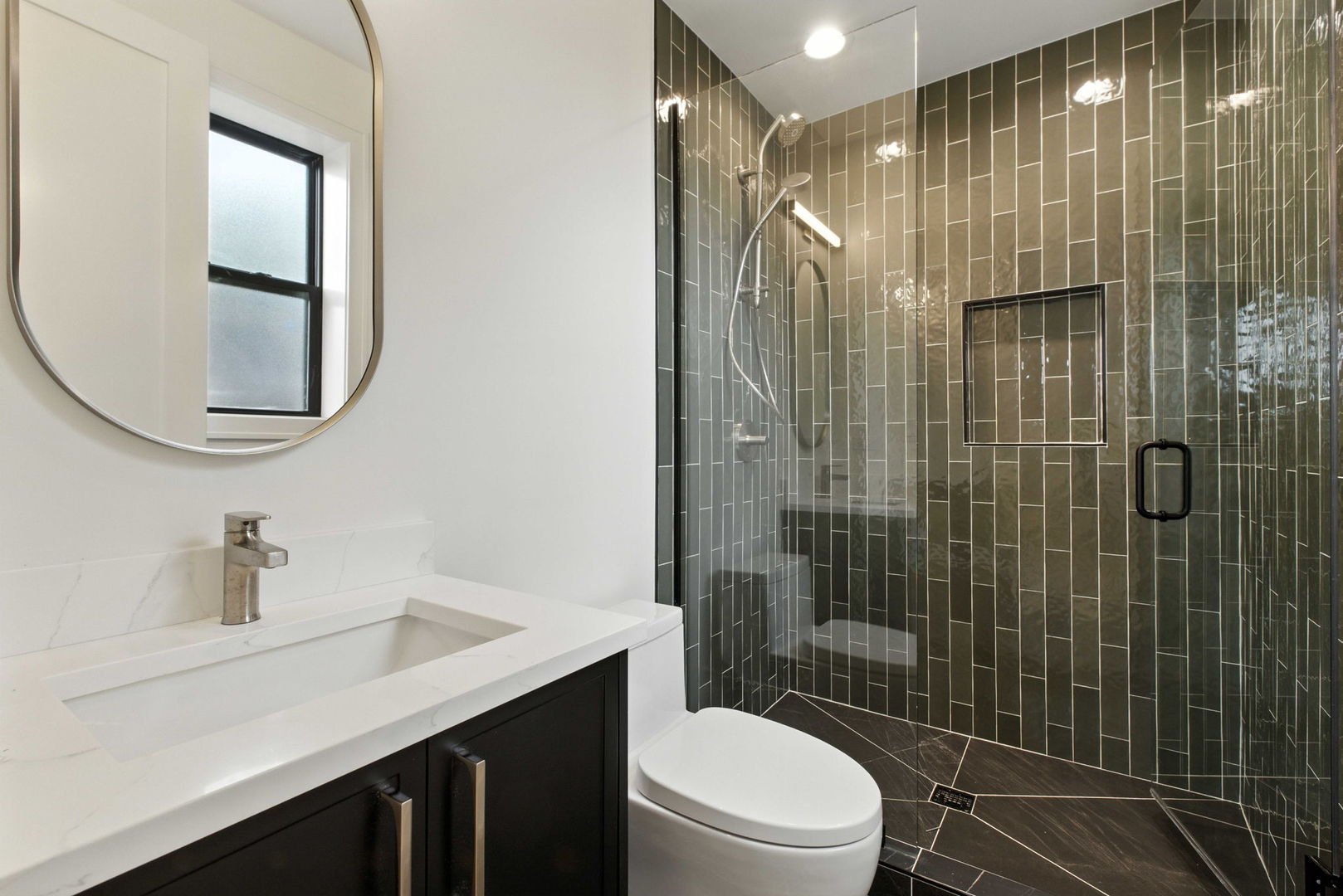 1443 West Roscoe Street, Unit 1 Chicago, IL 60657 - Photo 13 of 15 a bathroom with a sink toilet and shower