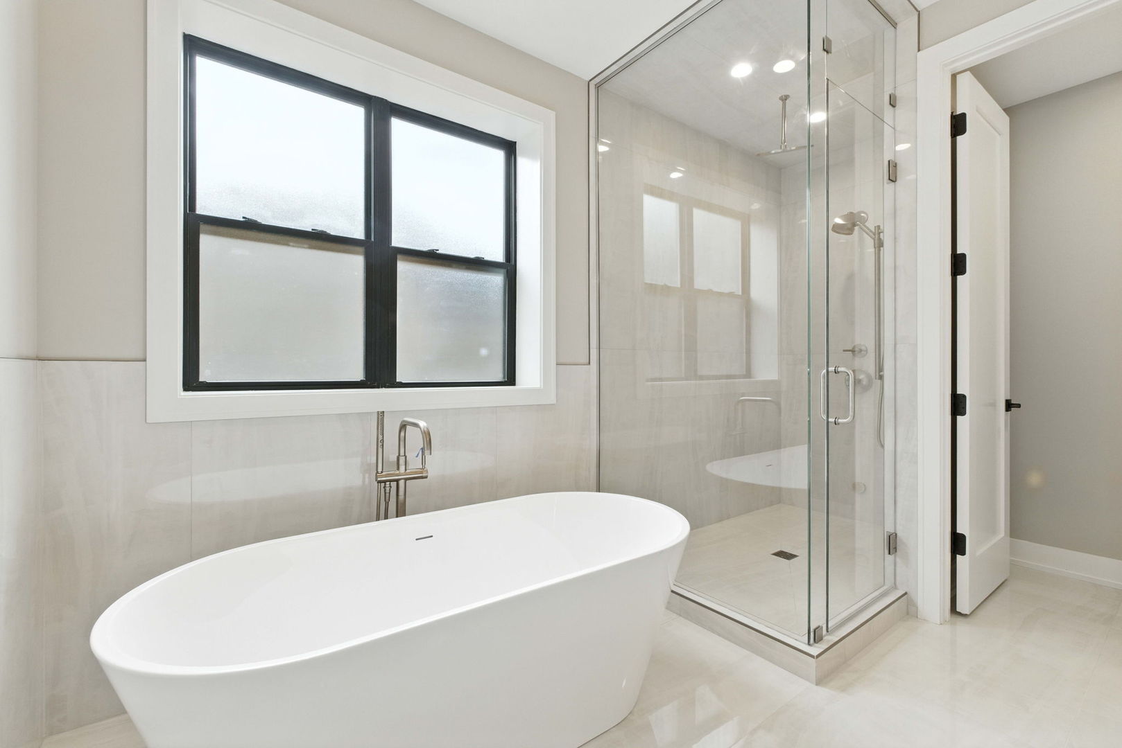 1443 West Roscoe Street, Unit 1 Chicago, IL 60657 - Photo 9 of 15 a white bath tub sitting next to a shower