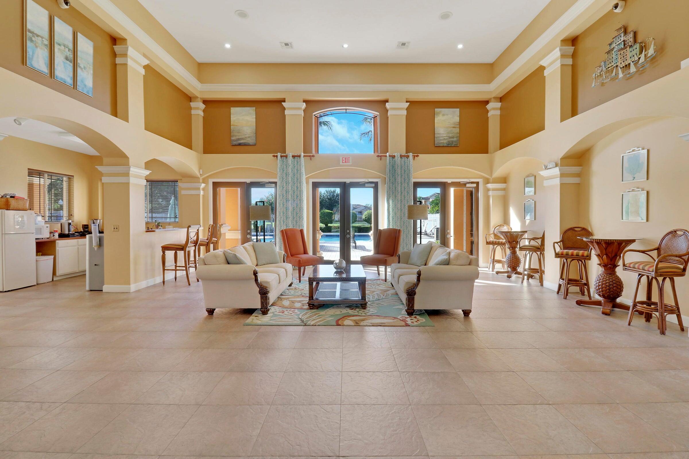 161 Southwest Palm Drive, Unit 205 Port St. Lucie, FL 34986 - Photo 14 of 22 a living room with furniture and large windows
