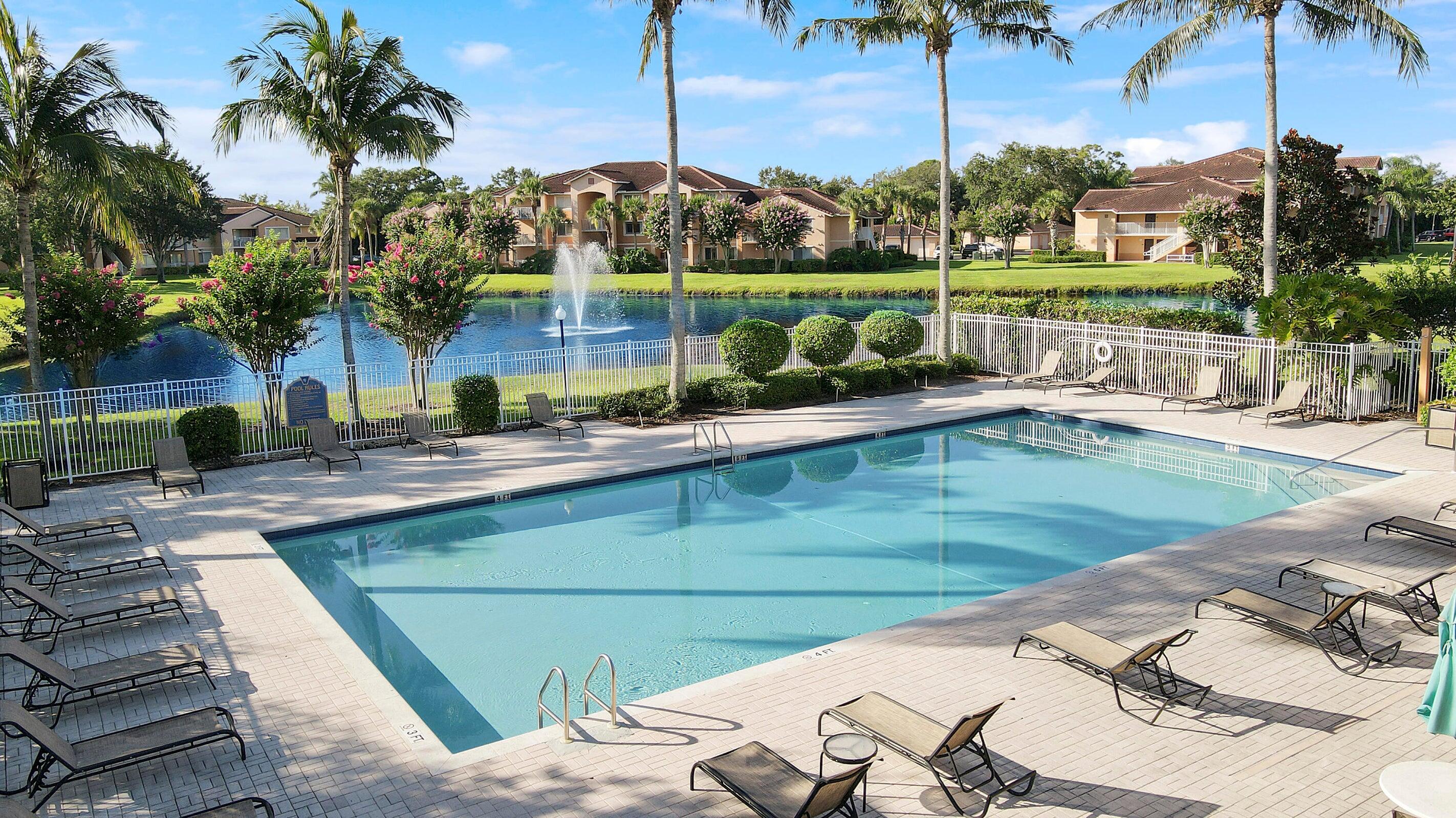 161 Southwest Palm Drive, Unit 205 Port St. Lucie, FL 34986 - Photo 17 of 22 a view of a swimming pool with a patio