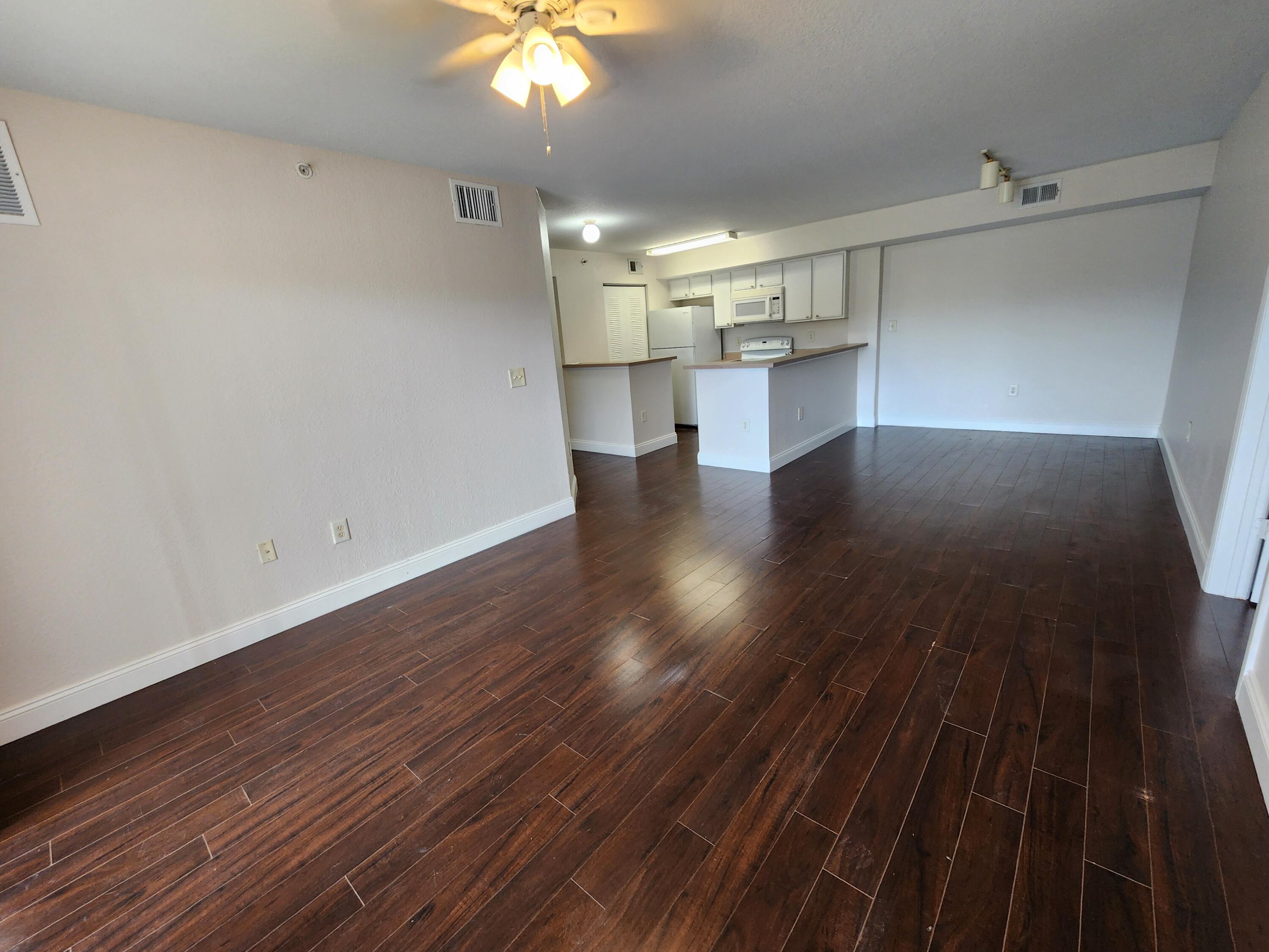 161 Southwest Palm Drive, Unit 205 Port St. Lucie, FL 34986 - Photo 21 of 22 wooden floor in an empty room with a window